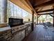 Well-equipped outdoor kitchen area featuring a built-in grill and stone accents at 549 Briarwood Ln, Lancaster, SC 29720