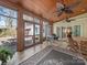 Elegant sunroom with tile flooring, and walls of windows with outdoor dining at 549 Briarwood Ln, Lancaster, SC 29720