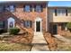 Charming brick townhome featuring a well-manicured front yard and traditional architectural details at 6108 Heath Ridge Ct, Charlotte, NC 28210