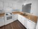Well-maintained kitchen with white appliances, cabinets and wood countertops at 6108 Heath Ridge Ct, Charlotte, NC 28210
