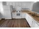 Clean kitchen features white appliances, cabinets, and wood countertops at 6108 Heath Ridge Ct, Charlotte, NC 28210