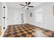 Bright bedroom features unique checkered floors, a ceiling fan, fresh paint, and ample natural light at 612 Miller St, Kannapolis, NC 28081