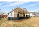 Side view of a traditional home featuring a covered porch with natural wood posts and a simple landscape at 612 Miller St, Kannapolis, NC 28081