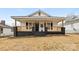 Charming home featuring a covered front porch, classic black shutters, and a well-maintained yard at 612 Miller St, Kannapolis, NC 28081