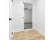 Hallway leads into another room with dark accents against neutral, light walls and light vinyl flooring at 612 Miller St, Kannapolis, NC 28081