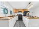 A kitchen features butcher block countertops, black and white tile floor, and stainless steel appliances at 612 Miller St, Kannapolis, NC 28081