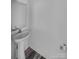 This powder room features a pedestal sink, modern faucet, and light gray flooring at 613 N Pink St, Cherryville, NC 28021
