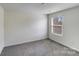 Bedroom with a large window, neutral walls, and soft carpeting at 613 N Pink St, Cherryville, NC 28021