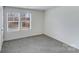 Bedroom featuring two windows, neutral walls, and carpeting at 613 N Pink St, Cherryville, NC 28021