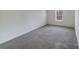 Neutral bedroom with wall to wall carpeting and a bright window at 613 N Pink St, Cherryville, NC 28021