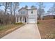 Charming two-story home with neutral siding and an attached garage on a slightly wooded lot at 613 N Pink St, Cherryville, NC 28021