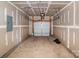 Unfinished two car garage showing the garage door with modern garage door opener at 613 N Pink St, Cherryville, NC 28021