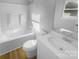 Clean, updated bathroom featuring a tub-shower combo, new toilet, and vanity with modern fixtures and hardwood floors at 6440 Tivoli Ct, Charlotte, NC 28211