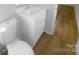 This bathroom features a modern vanity and toilet with wood-look flooring at 6440 Tivoli Ct, Charlotte, NC 28211