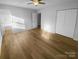 This bedroom features hardwood floors, a ceiling fan, and closet space at 6440 Tivoli Ct, Charlotte, NC 28211