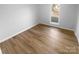 Bright bedroom with new floors, fresh paint and a large window letting in plenty of natural light at 6440 Tivoli Ct, Charlotte, NC 28211