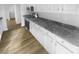 Bright kitchen with new floors, white cabinets and stainless steel appliances at 6440 Tivoli Ct, Charlotte, NC 28211