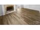 Open living room featuring new floors, a fireplace and plenty of natural light at 6440 Tivoli Ct, Charlotte, NC 28211