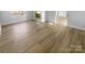 Open living room featuring new floors, a fireplace and plenty of natural light at 6440 Tivoli Ct, Charlotte, NC 28211