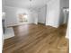 Open concept living space with hardwood floors, a decorative fireplace, and neutral walls flooded with natural light at 6440 Tivoli Ct, Charlotte, NC 28211