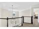 Bright landing with a view of the entryway chandelier and staircase at 6565 Derby Nw Ln, Concord, NC 28027