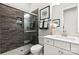 Modern bathroom with a tiled shower, white vanity, and decorative mirror at 6727 Baker Creek Ave, Indian Land, SC 29707