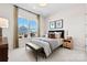 Cozy bedroom with a large window, neutral colors, and modern furnishings at 6727 Baker Creek Ave, Indian Land, SC 29707