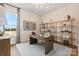 Bright home office with modern desk, ample shelving, and a large window offering pleasant views at 6727 Baker Creek Ave, Indian Land, SC 29707