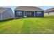 A large, neatly cut backyard lawn complements this home with a screened in porch at 8422 Norman Forest Rd, Lancaster, SC 29720