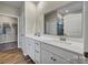 Bathroom featuring double vanity with white cabinets, countertops, and a large mirror at 8422 Norman Forest Rd, Lancaster, SC 29720