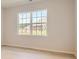 Bright and airy bedroom featuring hardwood floors and large windows offering serene backyard views at 8422 Norman Forest Rd, Lancaster, SC 29720