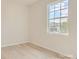 Cozy bedroom featuring hardwood floors, neutral paint, and a large window providing natural light at 8422 Norman Forest Rd, Lancaster, SC 29720