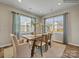 Bright dining room with a wooden table, seating for six, and large windows with natural light at 8422 Norman Forest Rd, Lancaster, SC 29720