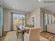 Bright dining room with a wooden table, seating for six, and large windows with natural light at 8422 Norman Forest Rd, Lancaster, SC 29720