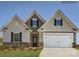 Charming home featuring a stone-accented facade, two-car garage, and well-manicured lawn at 8422 Norman Forest Rd, Lancaster, SC 29720