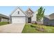 Charming home featuring a two-car garage, stone accents, well-maintained lawn, and inviting curb appeal at 8422 Norman Forest Rd, Lancaster, SC 29720