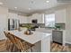 Bright, modern kitchen with white cabinetry, stainless steel appliances, a large island, and stylish fixtures at 8422 Norman Forest Rd, Lancaster, SC 29720