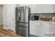Close-up of a modern kitchen featuring stainless steel refrigerator, white cabinets, and a stylish countertop at 8422 Norman Forest Rd, Lancaster, SC 29720