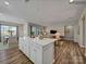 Spacious open-concept kitchen with a large island, white cabinets, and a view into the living room at 8422 Norman Forest Rd, Lancaster, SC 29720