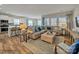 Open concept living room with large windows, hardwood floors, and contemporary furnishings, and a view into the kitchen at 8422 Norman Forest Rd, Lancaster, SC 29720