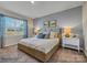 A bedroom with large window and an elegant bed flanked by nightstands and lamps at 8422 Norman Forest Rd, Lancaster, SC 29720