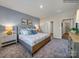 A bedroom with large window and an elegant bed flanked by nightstands and lamps at 8422 Norman Forest Rd, Lancaster, SC 29720