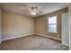 This bedroom is carpeted and includes a ceiling fan and a window at 924 41St Avenue Ne Dr, Hickory, NC 28601