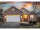 Charming brick home with a two-car garage, landscaped yard, and warm exterior lighting at 924 41St Avenue Ne Dr, Hickory, NC 28601
