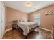 Bedroom with wood floors, a double window, and neutral paint at 9566 Turning Wheel Dr, Charlotte, NC 28214