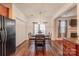 Bright dining area with hardwood floors, a contemporary light fixture, and convenient access to the kitchen at 9566 Turning Wheel Dr, Charlotte, NC 28214