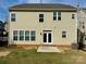 View of the rear exterior with patio, sodded lawn, and double doors at 1019 Dunhill Ln, Waxhaw, NC 28173