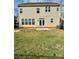 A fully sodded backyard, including a patio and view of the home's rear exterior at 1019 Dunhill Ln, Waxhaw, NC 28173