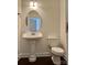 Cozy half bath features a pedestal sink and toilet with neutral wall color at 1019 Dunhill Ln, Waxhaw, NC 28173