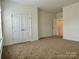 Neutral bedroom features carpeting, base trim, and a closet at 1019 Dunhill Ln, Waxhaw, NC 28173